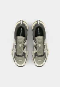 Light grey and dark grey mesh sneakers with a textured upper, elastic laces, and a cushioned sole. "MERRELL MATIS" branding visible inside.