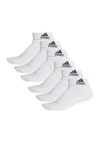 White athletic socks featuring a ribbed cuff, black Adidas logo, and a short design. Six pairs are displayed in a row.