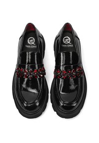 Mocassini in vernice nera con punta rotonda, caratterizzati da una fascia decorativa impreziosita da gioielli rossi e neri sulla tomaia.