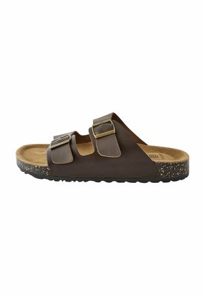Braune Leder-Slidesandale mit zwei verstellbaren Riemen, goldenen Schnallen und einem Korkfußbett. Texturierte Sohle mit sprenkelnden Akzenten.