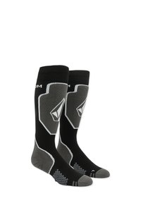 Chaussettes noires et grises à mi-mollet avec un grip hexagonal sur la semelle, présentant un design de logo argenté et des détails de piping contrastants.