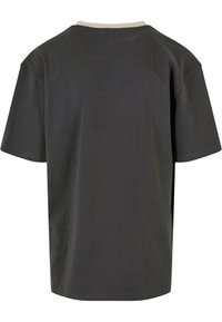 Dark gray t-shirt with short sleeves, a round neckline, and a light-colored, ribbed collar. The fabric appears smooth and lightweight.