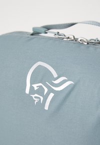 Gray fabric bag featuring a textured surface, a smooth silver logo, and a strap with a chain accent for style and functionality.