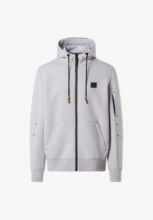 Felpa zip grigia chiara con cappuccio, due tasche frontali e cuciture nere. Presenta dettagli in verde per i lacci e un logo sul petto.
