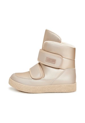 Beige faux leren enkellaarsjes met twee klittenbandsluitingen, een gevoerde kraag en een gestructureerde rubberen zool. Glad afwerking en zachte binnenvoering.