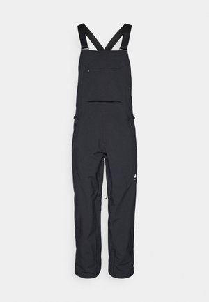 Black waterproof overalls with adjustable straps, front pocket, and zippered side pockets. Features a logo on the lower leg.