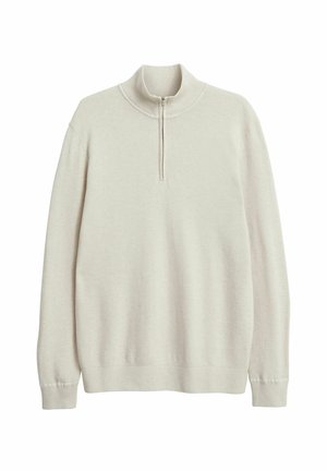 Lichtbeige pullover trui gemaakt van een gegarensweven stof. Heeft een kraag met halve ritssluiting en lange mouwen met ribgebreide manchetten en zoom.
