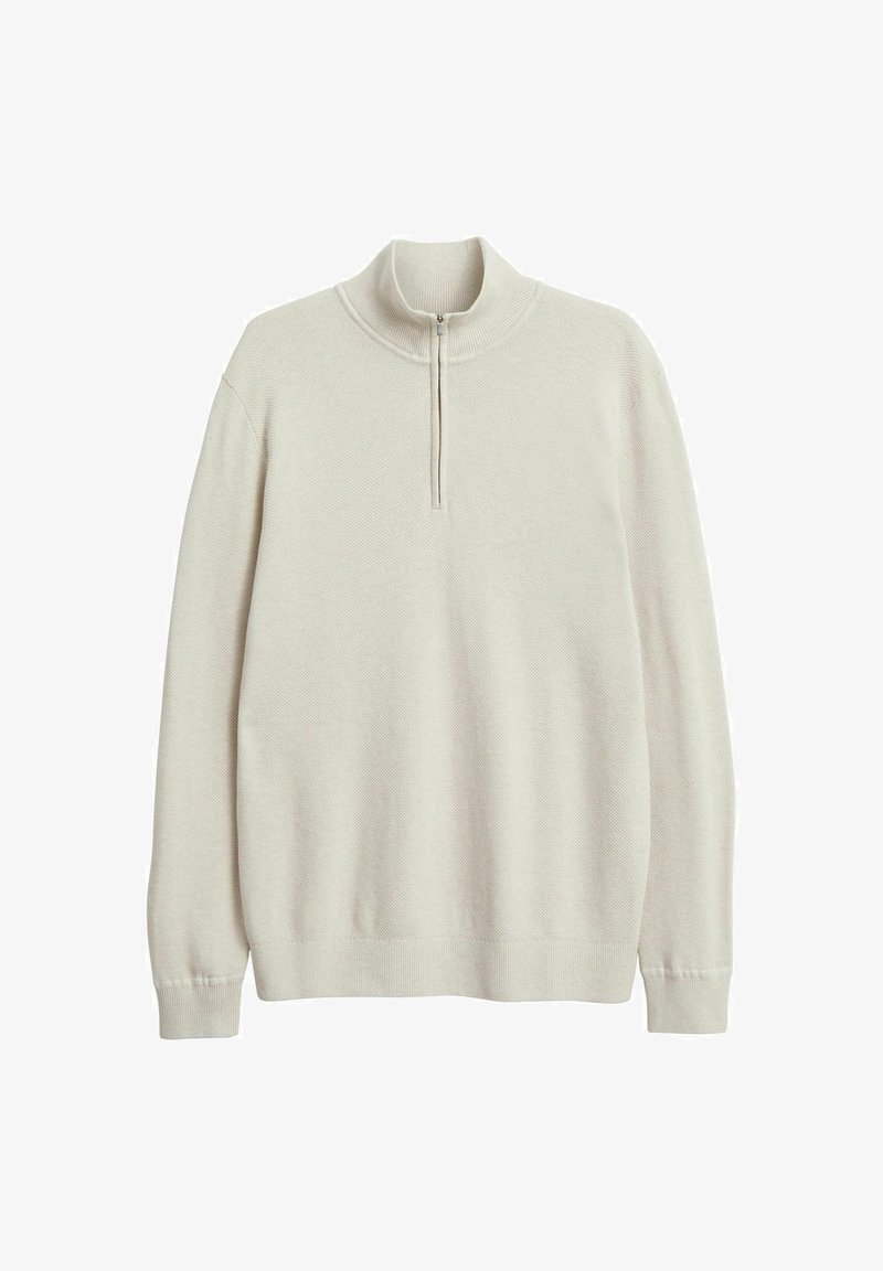 Helle beige Pullover-Strickjacke aus strukturiertem Strickstoff. Mit einem halben Reißverschlusskragen und langen Ärmeln mit gerippten Bündchen und Saum.