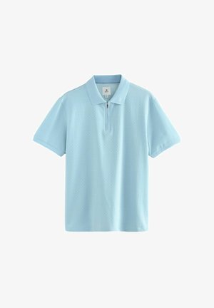 Ljusblå polo tröja med dragkedja i kragen, korta ärmar och textil med en subtil struktur.