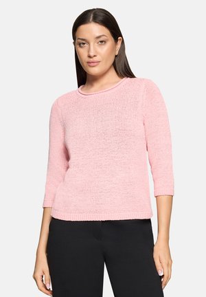 Light pink knitted sweater with a round neckline and three-quarter sleeves, featuring a loose, textured weave and ribbed hem.