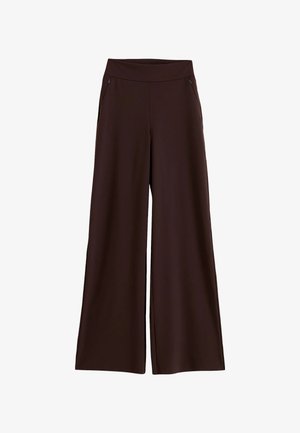 Pantalones anchos de pierna ancha de color marrón oscuro con cintura alta y dos bolsillos delanteros con cremallera, exhibidos sobre un fondo blanco.