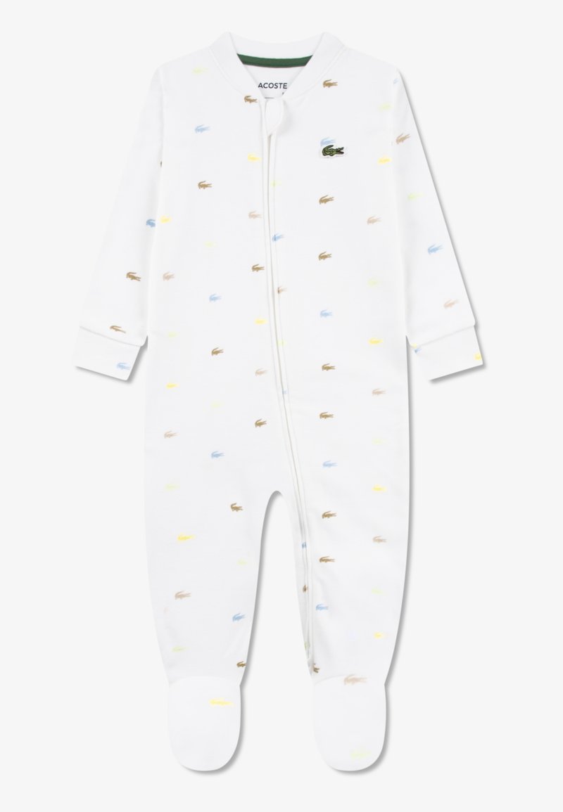 Λευκό βαμβακερό φορμάκι με πολύχρωμα σχέδια κροκοδείλων σε μπλε, κίτρινο και καφέ. Διαθέτει φερμουάρ εμπρός και καλυμμένα πόδια.