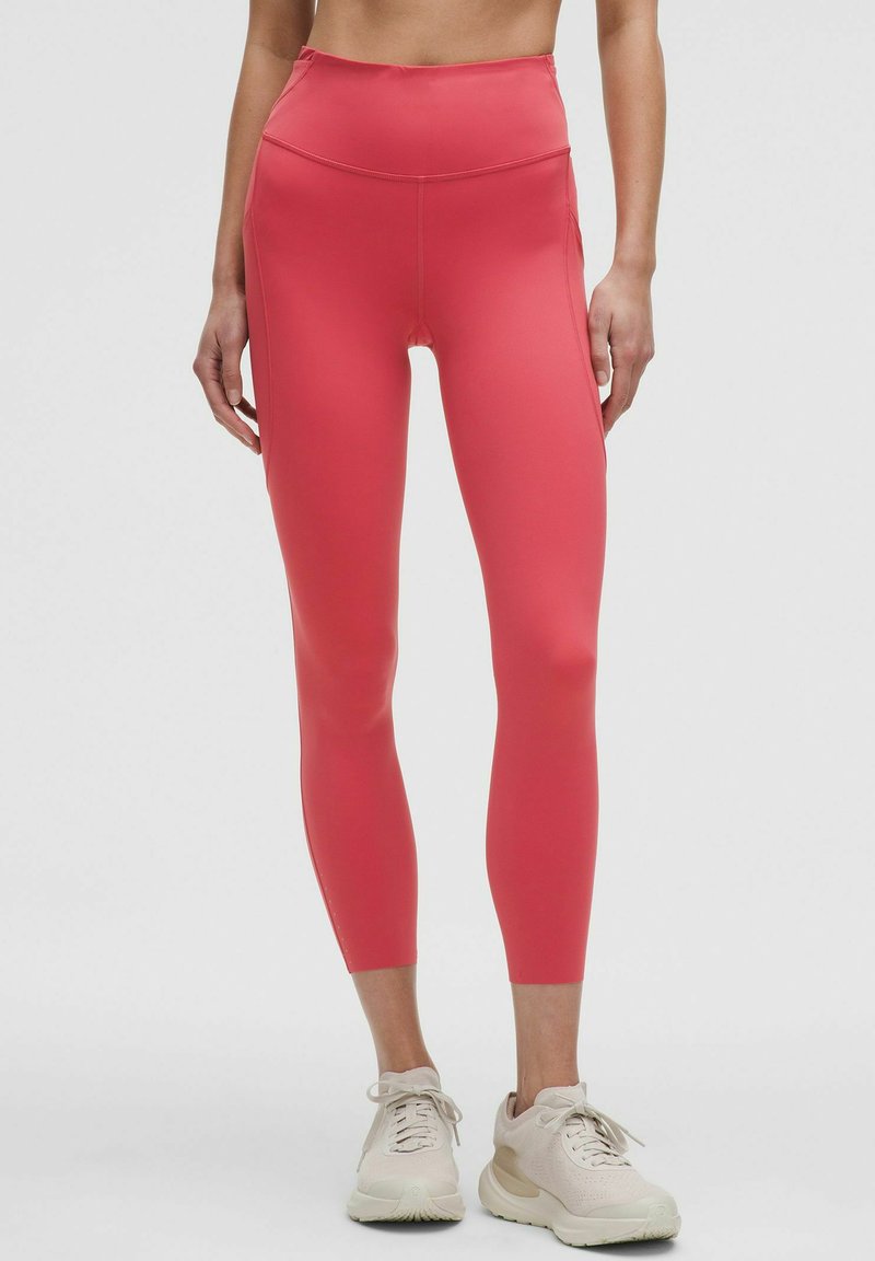 Legginsy z wysokim stanem, dopasowane, w jaskrawym różu, wykonane z gładkiego, elastycznego materiału. Posiadają bezszwową konstrukcję bez widocznych elementów metalowych.