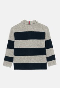 Suéter tricotado riscado em cinza e azul marinho escuro, com mangas longas e um colarinho curto, apresentando um detalhe de risca em vermelho, branco e preto.