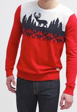 Red knit sweater featuring a white upper panel with a black woodland scene and reindeer design, finished with a patterned hem.