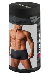 Black boxer briefs packaged in a cylindrical container with a camouflage design. Container features a clear front panel displaying the product.