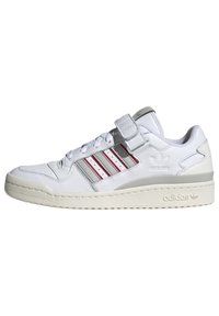 White leather sneaker with gray accents, three red stripes, lace and Velcro closure, textured toe cap, and a thick cream rubber sole.