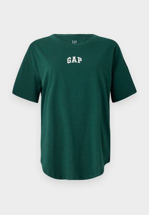 Grønn oversized t-skjorte laget av bomull, med rund halslinning og korte ermer. Hvitt "GAP"-logo brodert på brystet.