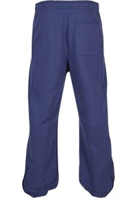 Marineblaue Sweatpants mit elastischem Taillenbund, seitlichen Taschen und einer Gesäßtasche. Aus weichem Stoff mit lockerer Passform und konischen Beinen.