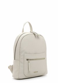 Small textured light gray leather backpack with front zipper pocket and top handle, shown at a slight angle on white background.