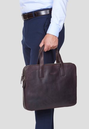 Dark brown leather briefcase with two top handles, zip closure, and smooth texture. Features a subtle logo embossing on the front.