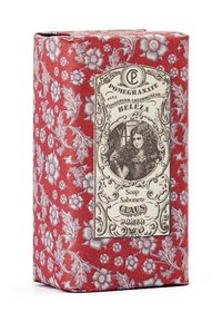 Red floral-patterned box, featuring a vintage label with an illustration. Text reads “Pomegranate Soap” and “Claus Porto.” Textured paper surface.