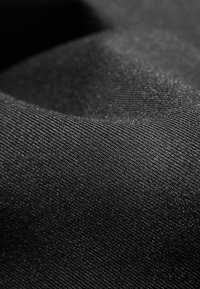 Black fabric featuring a fine, textured weave. The material has a smooth appearance with subtle sheen and consistent color throughout.