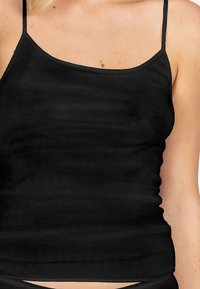 Black tank top with thin straps, made of soft, stretchy fabric. Features a fitted design and smooth texture, suitable for layering.