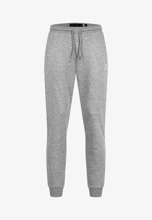 Pantaloni jogger in cotone grigio chiaro con elastico in vita, coulisse e polsini alle caviglie, con un piccolo logo discreto sulla coscia destra.