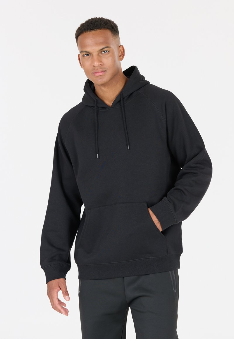 Svart fleece-hoodie med en känguruficka, dragsko och ribbade ärmar, som har en klassisk design med huva och mjuk textur.