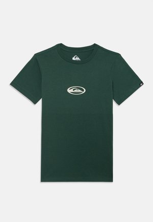 Dark green cotton t-shirt featuring a cream-colored logo graphic centered on the chest and a small black tag on the left sleeve.