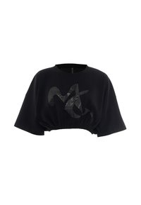 T-shirt noir raccourci avec des manches larges, ourlet élastique et un graphique abstrait noir brillant sur le devant.