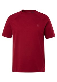 T-shirt in cotone rosso con scollo rotondo e maniche raglan corte. Caratterizzato da un logo JP minimalista di una tonalità leggermente più scura. Texture liscia.