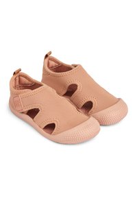 Roza slip-on čevlji z izrezljanim dizajnom, strukturni gumijasti podplati in zgornji del iz elastične tkanine. Okrogla konica in majhna zanka za enostavno obuvanje.