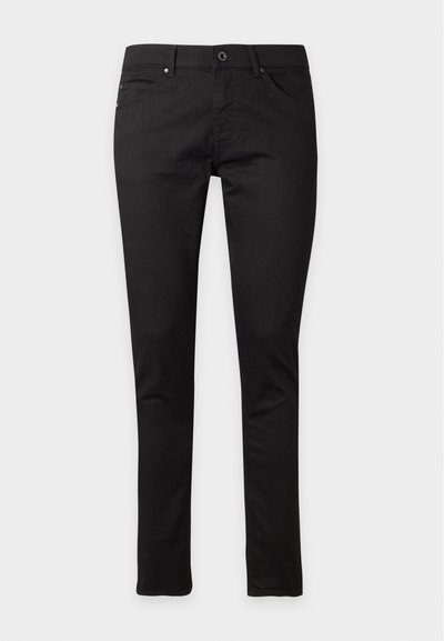 Čierne slim fit džínsy so zapínaním na gombík a zips, predné a zadné vrecká, zobrazené natiahnuté na bielom pozadí.