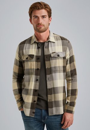 Flanellhemd mit großem Karomuster in Beige, Grau und Dunkelgrün, zwei Brusttaschen, schwarzen Knöpfen und einem Kragen.