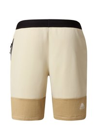 Béžové plavky s černým páskem a texturovanými opálenými akcenty na spodní části. Disponují boční kapsou na zip pro uložení věcí.