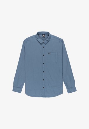 Blauwe longsleeve met knoopsluiting aan de voorkant, klassieke kraag, een zak aan de linkerkant van de borst en zwarte knopen. Gemaakt van een zachte, gestructureerde stof.