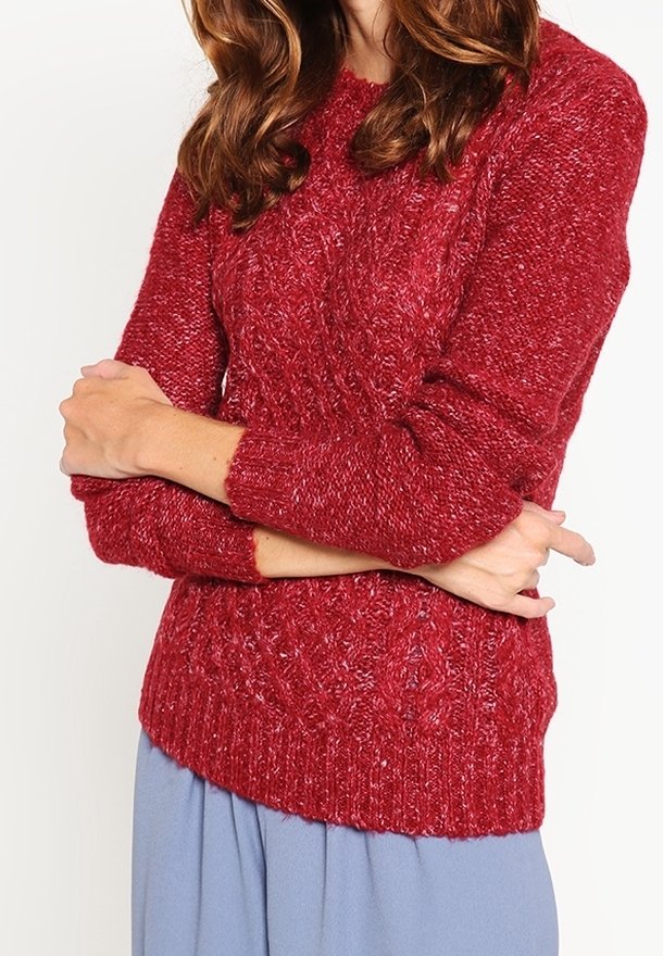 Red knitted sweater with a textured pattern, round neckline, and long sleeves. The fabric appears thick and warm, ideal for colder weather.