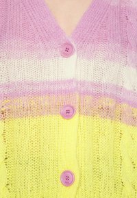 Knitted cardigan with pink, cream, and yellow horizontal stripes. Features round pink buttons and a textured, lightweight design.