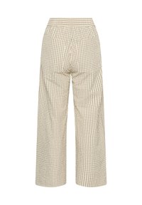 Pantalon beige à jambes larges avec un motif à carreaux noirs et une taille élastique, vu de dos.
