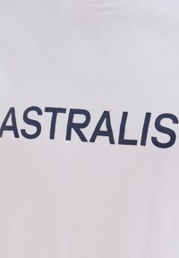 Hvid bomulds T-shirt med fed mørkeblå tekst, der står "ASTRALIS." Stoffet virker glat med en standard rund hals.