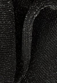 Black fabric with a ribbed texture, featuring fine metallic threads that create a shimmering effect throughout the material.