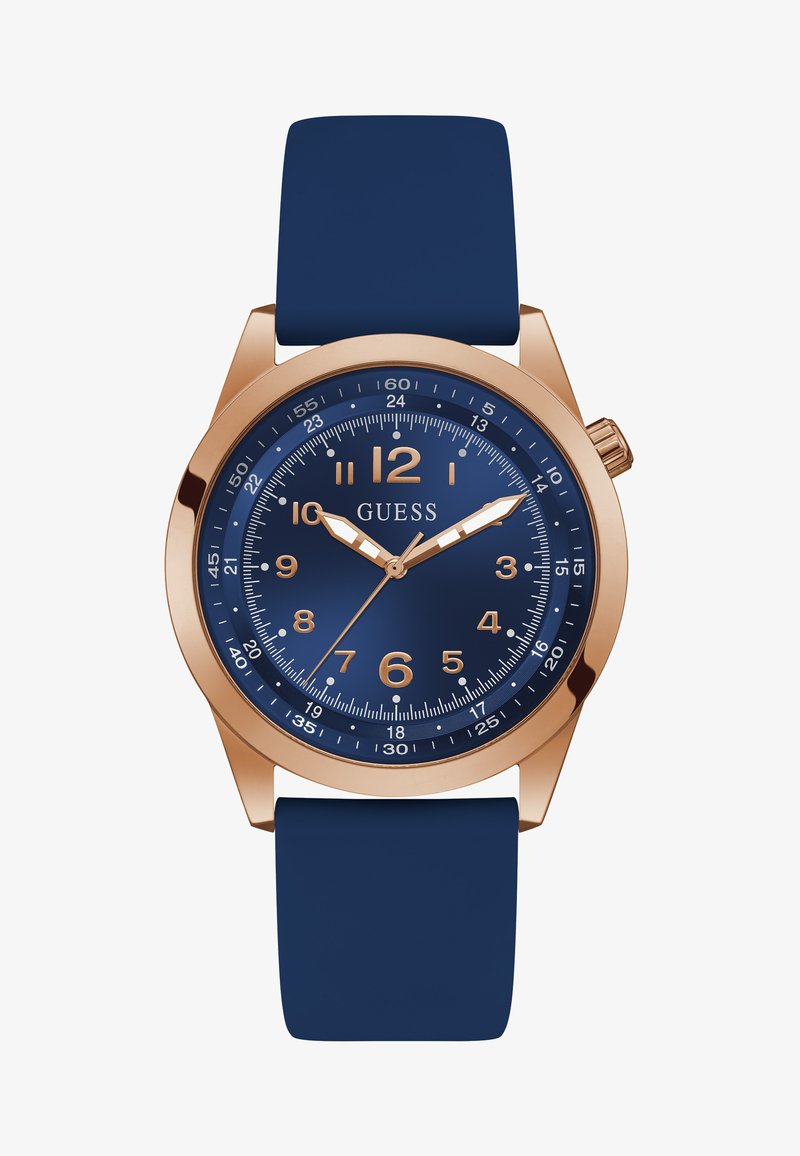 Tengerészett kék szilikon szíjjal készült óra rózslakk arany színű fém házzal, kerek óralappal és kék számlappal, amelyen fehér órajelzők és mutatók találhatók.