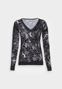 Pull long à manches longues imprimé serpent noir et blanc avec un col en V et une bande scintillante à l'ourlet. Texture douce et design ajusté.