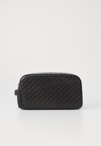 Black synthetic toiletry bag with a textured diamond pattern, rectangular shape, smooth finish, and a side handle. Silver zipper accent.