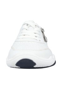 White sneaker featuring a textured surface, perforated design, round toe, and a silver zipper accent on the side. Black outsole.