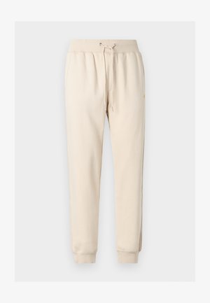 Pantalon de jogging beige avec une taille élastique, un cordon de serrage, des poches latérales et des poignets côtelés.
