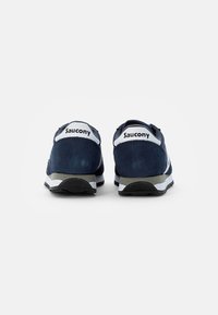 Navy blue suede and mesh sneakers with white accents and logo, featuring a padded collar and textured rubber sole for grip and support.