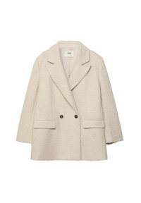 Beige dubbelzijdige jas van een gestructureerde, harige stof. Voorzien van gekartelde revers, twee voorkantzakken en zwarte knopen.